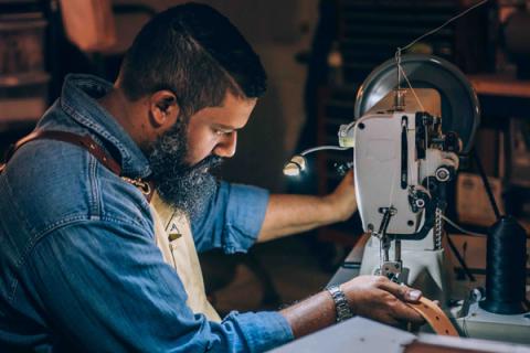 man working with leather